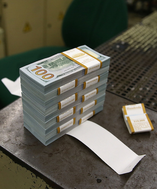 WASHINGTON, DC - MAY 20: A stack of newly redesigned $100 notes sits on a bench at the Bureau of Engraving and Printing on May 20, 2013 in Washington, DC. The one hundred dollar bills will be released this fall and has new security features, such as a duplicating portrait of Benjamin Franklin and microprinting added to make the bill more difficult to counterfeit.  (Photo by Mark Wilson/Getty Images)