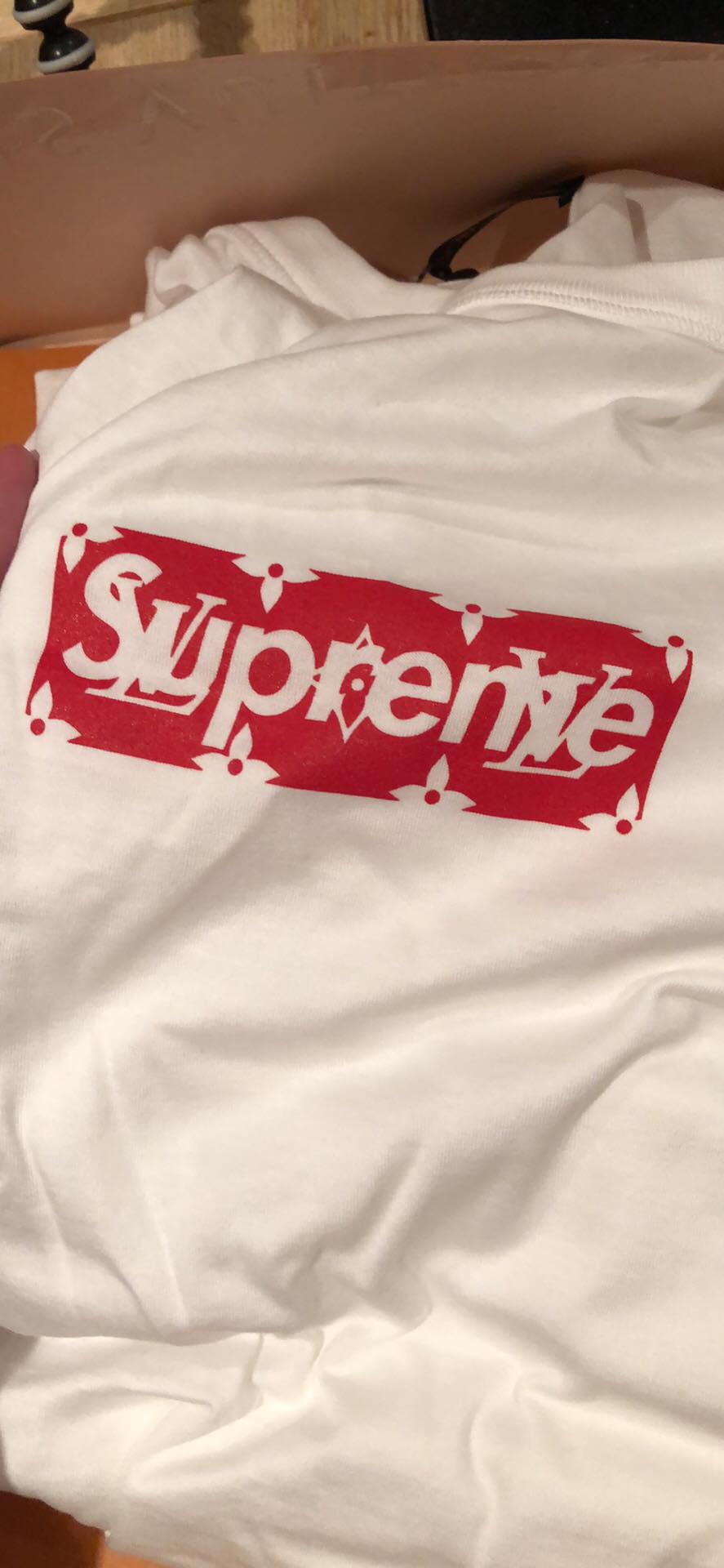 Step 2: Real vs fake Supreme x Louis Vuitton neck tag